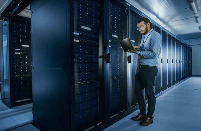 IT professional working beside modern server infrastructure